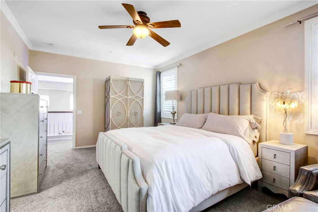 12422 Benton Drive, Unit 1 Rancho Cucamonga, CA 91739 - Photo 13 of 20 a bedroom with a large bed and a chandelier