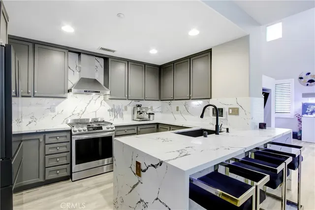 a kitchen with granite countertop a sink stove and cabinets