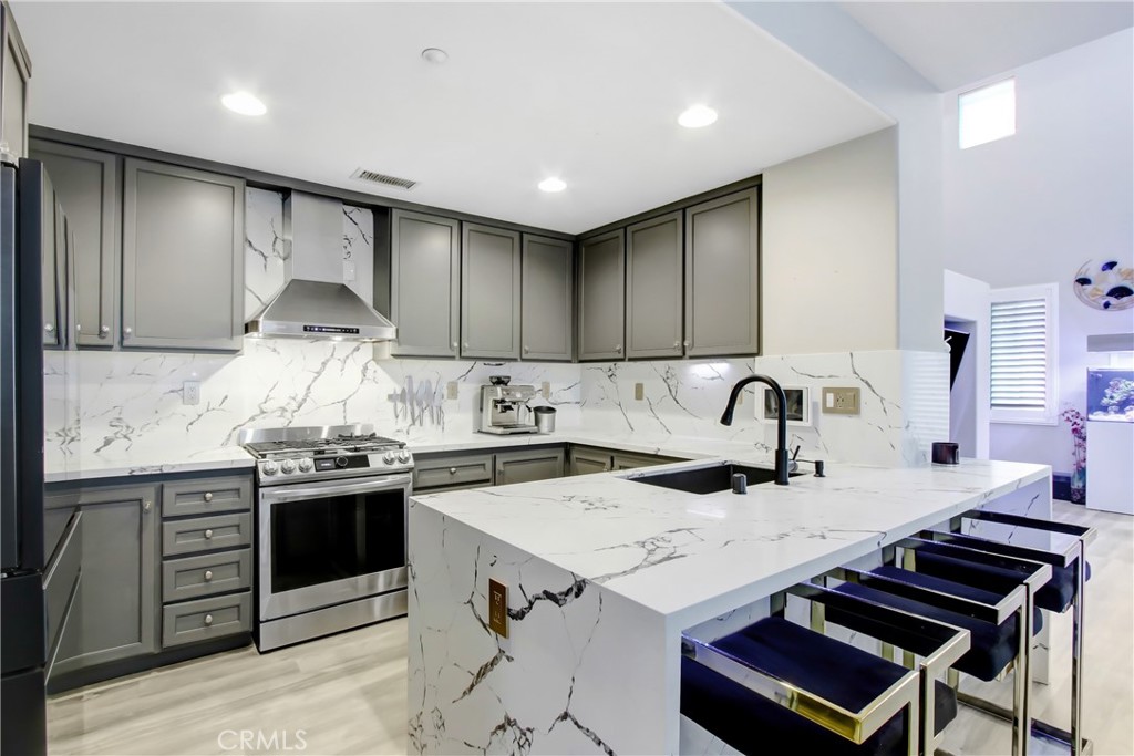12422 Benton Drive, Unit 1 Rancho Cucamonga, CA 91739 - Photo 3 of 20 a kitchen with granite countertop a sink stove and cabinets