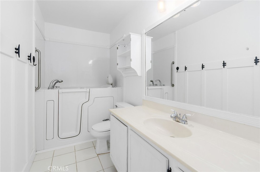 29368 Murrieta Road Menifee, CA 92586 - Photo 13 of 20 a bathroom with a granite countertop sink a toilet and a shower