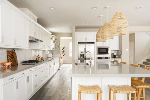a kitchen with stainless steel appliances kitchen island granite countertop a sink and cabinets