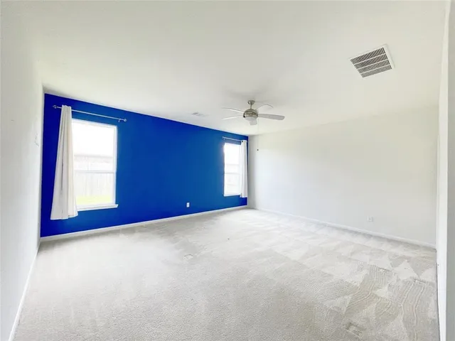 a view of an empty room with windows