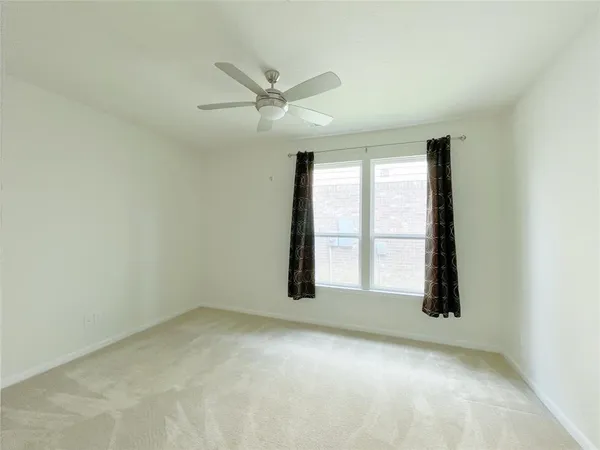 an empty room with windows and closet