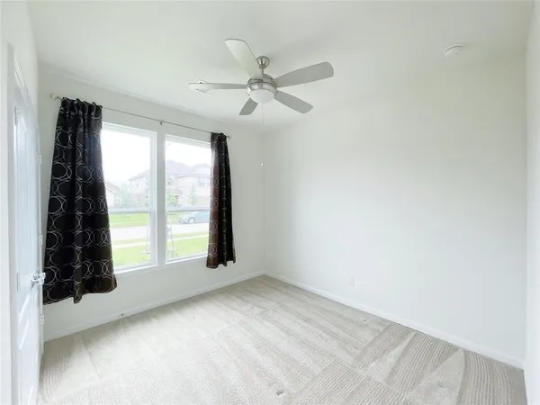 an empty room with windows and closet
