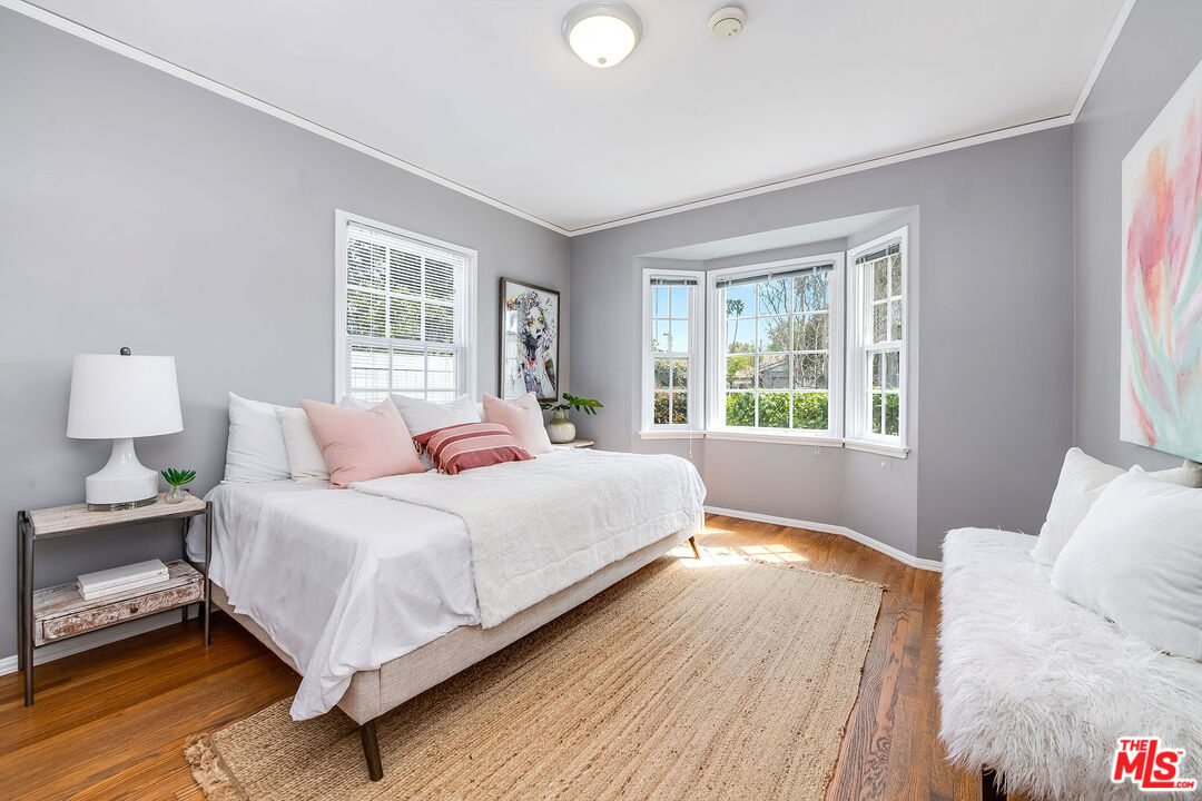 4539 Atoll Avenue Sherman Oaks, CA 91423 - Photo 15 of 28 a bedroom with a bed lamp and window