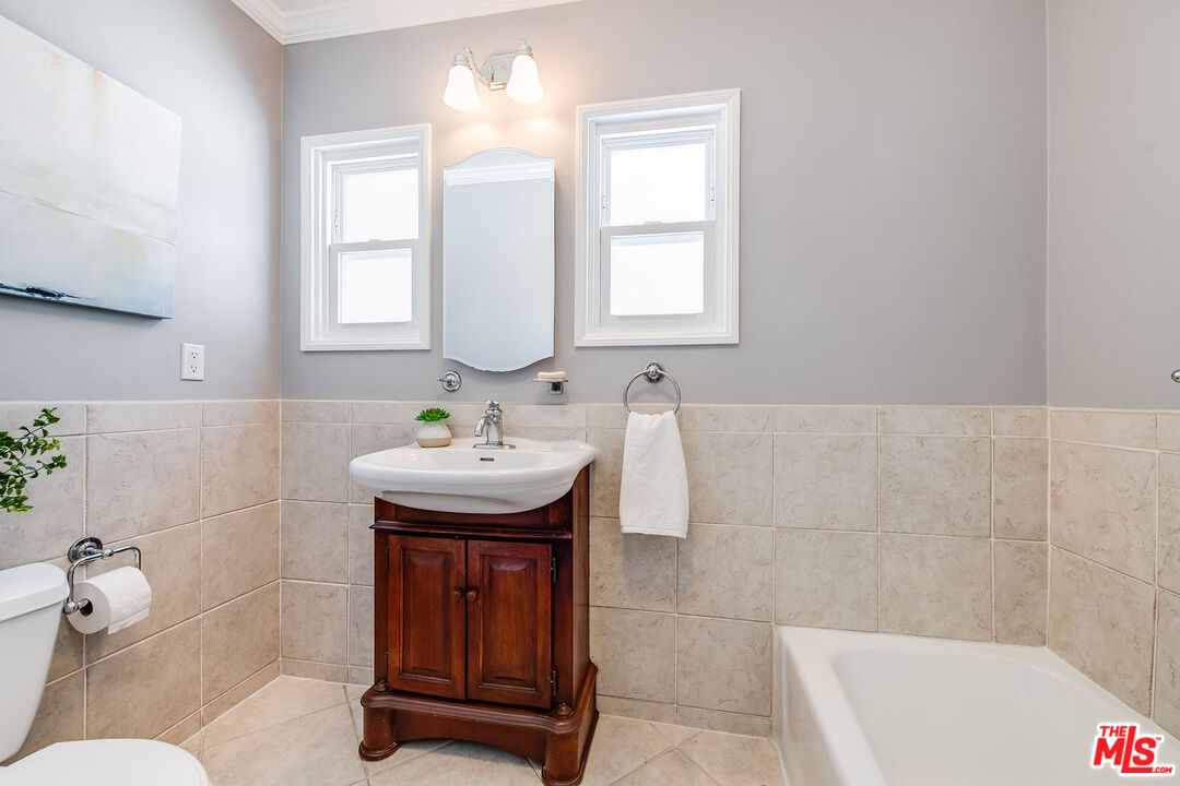 4539 Atoll Avenue Sherman Oaks, CA 91423 - Photo 16 of 28 a bathroom with a sink a toilet and tub