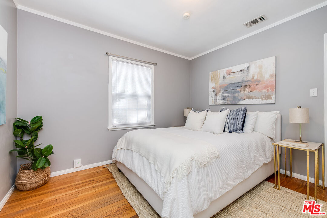 4539 Atoll Avenue Sherman Oaks, CA 91423 - Photo 19 of 28 a bedroom with a bed and a potted plant