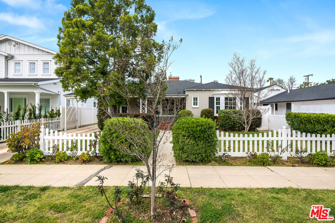 4539 Atoll Avenue Sherman Oaks, CA 91423 - Photo 2 of 28 a front view of a house with a garden