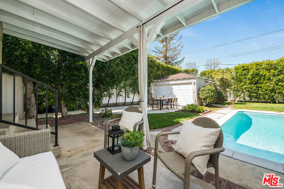 4539 Atoll Avenue Sherman Oaks, CA 91423 - Photo 23 of 28 a view of a patio with a table chairs and a backyard