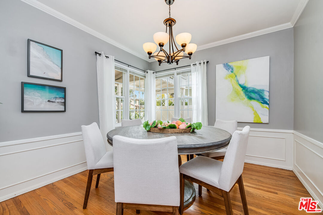4539 Atoll Avenue Sherman Oaks, CA 91423 - Photo 8 of 28 a dining room with wooden floor and a chandelier