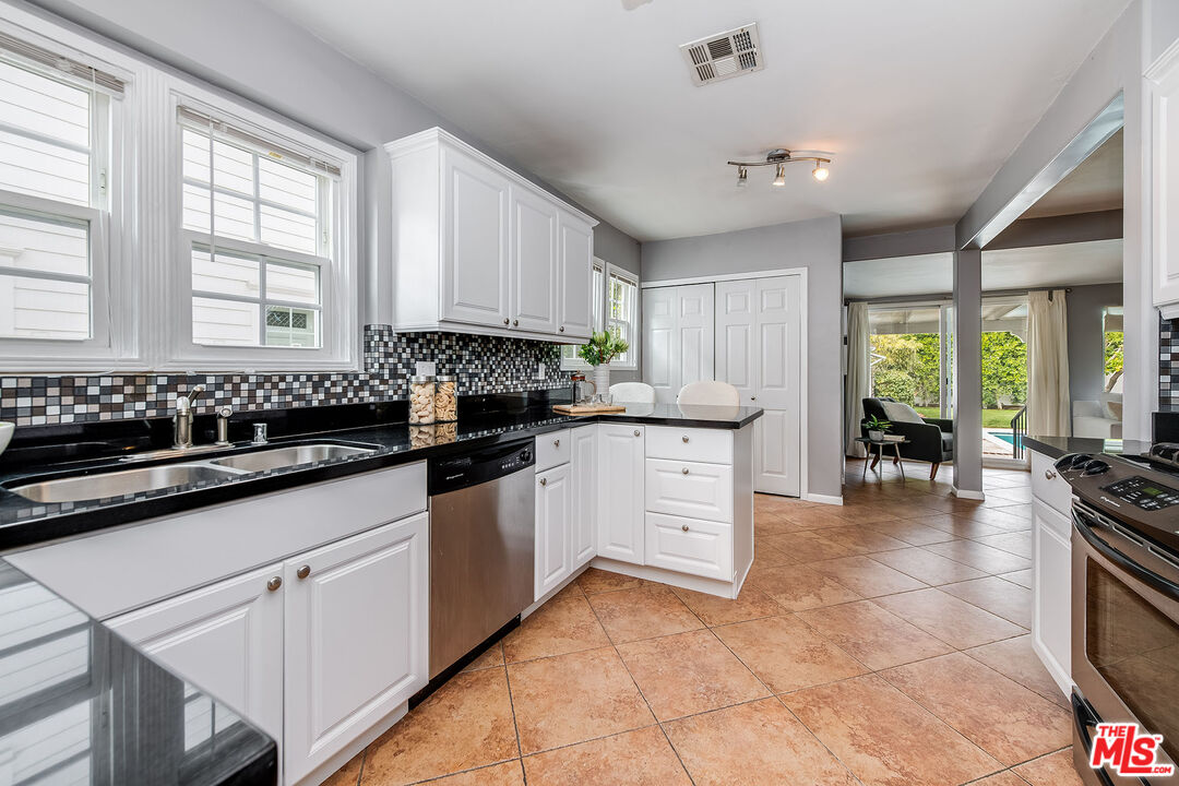 4539 Atoll Avenue Sherman Oaks, CA 91423 - Photo 9 of 28 a kitchen with a sink stove and cabinets