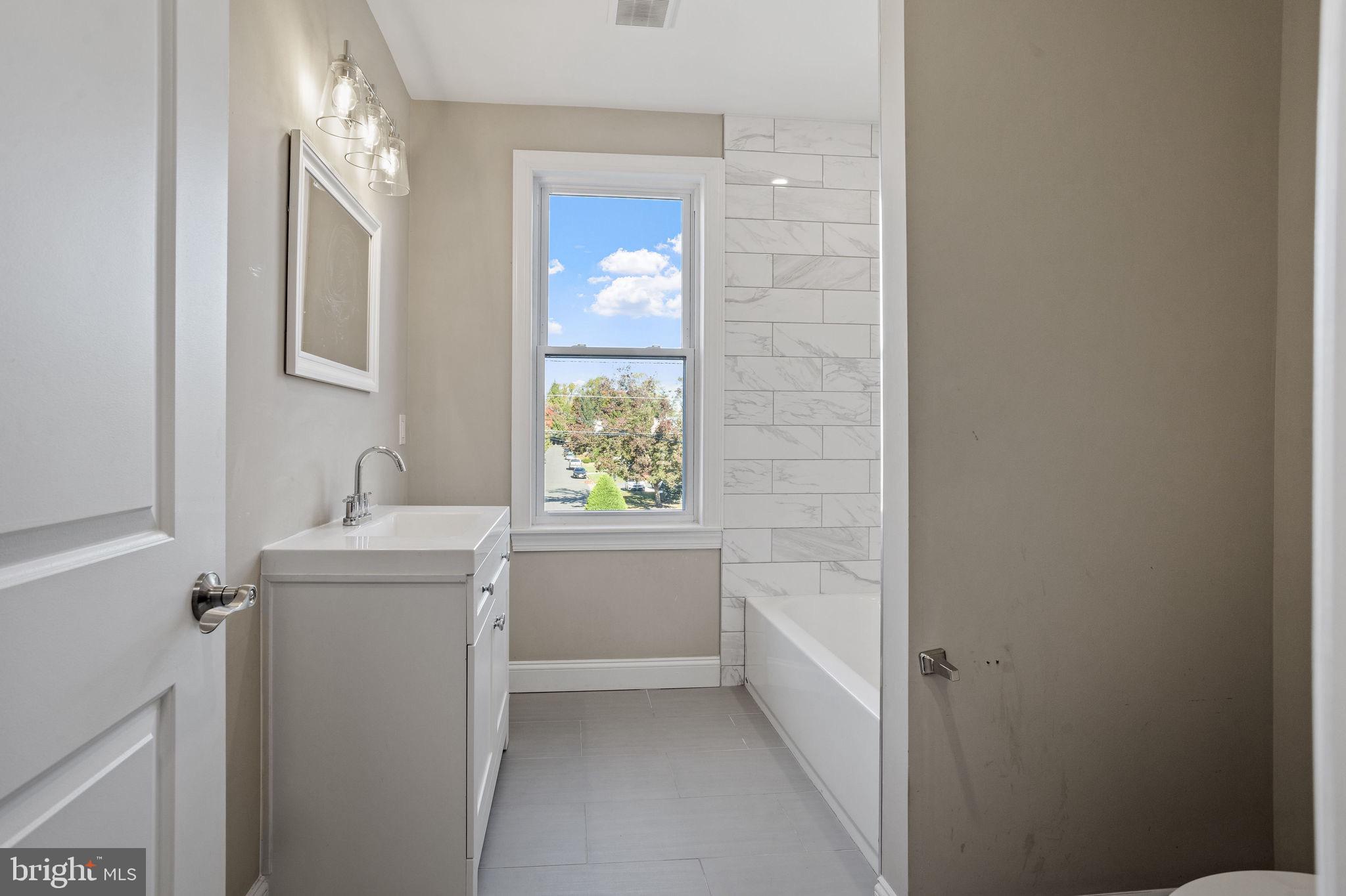 144 Snyder Place Moorestown, NJ 08057 - Photo 11 of 36 a bathroom with a bathtub sink and mirror