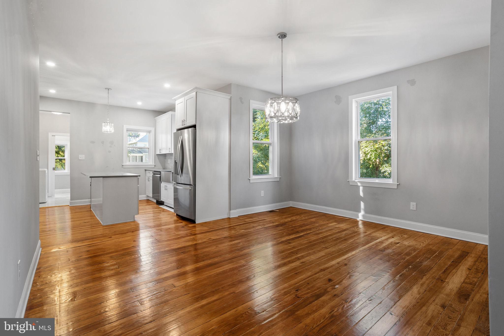 144 Snyder Place Moorestown, NJ 08057 - Photo 14 of 36 a view of an empty room with wooden floor kitchen view and a window
