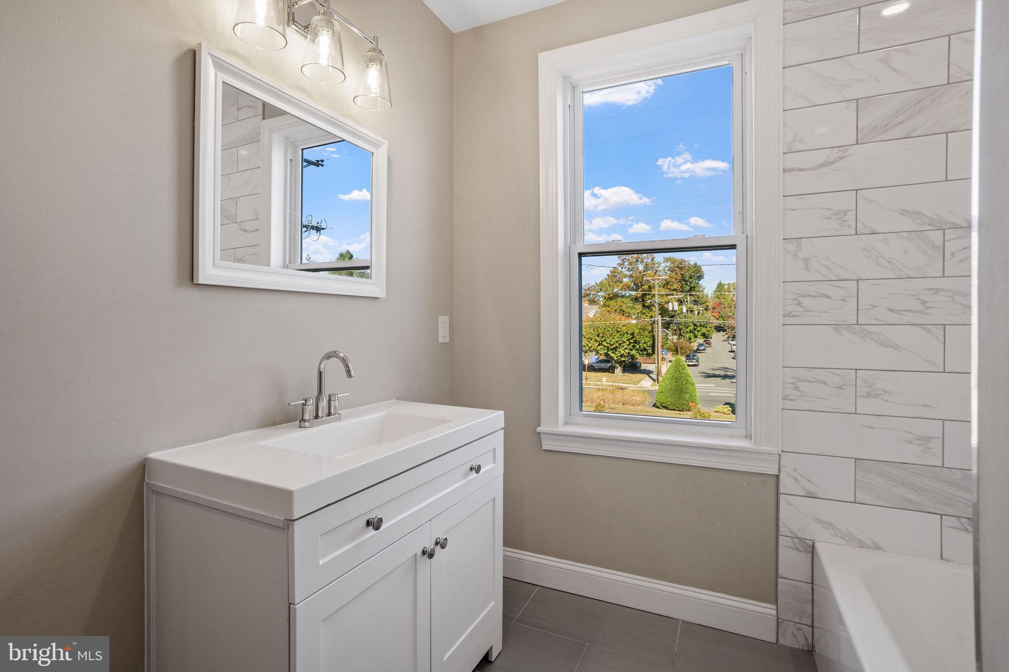 144 Snyder Place Moorestown, NJ 08057 - Photo 15 of 36 a bathroom with a sink a vanity and a mirror