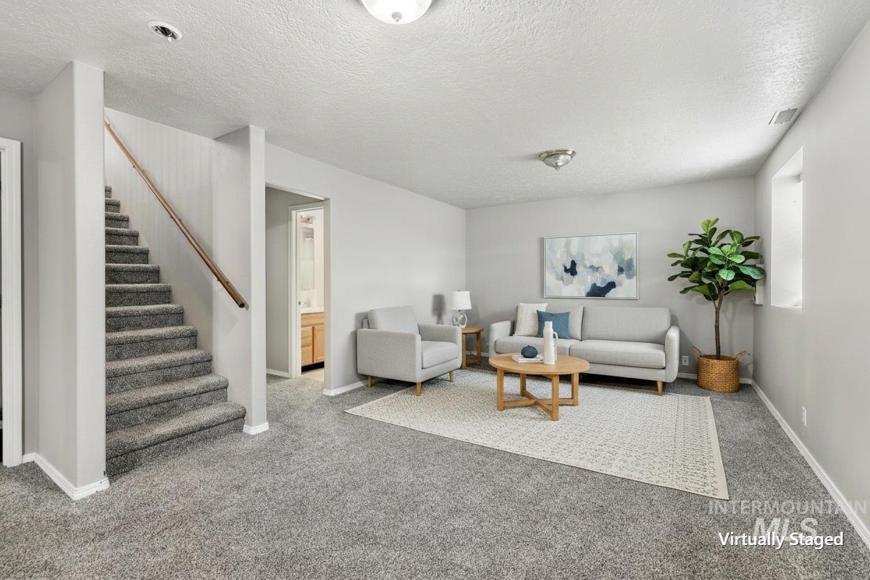 445 South College Street Oakley, ID 83346 - Photo 11 of 24 Carpeted staircase with wood railing