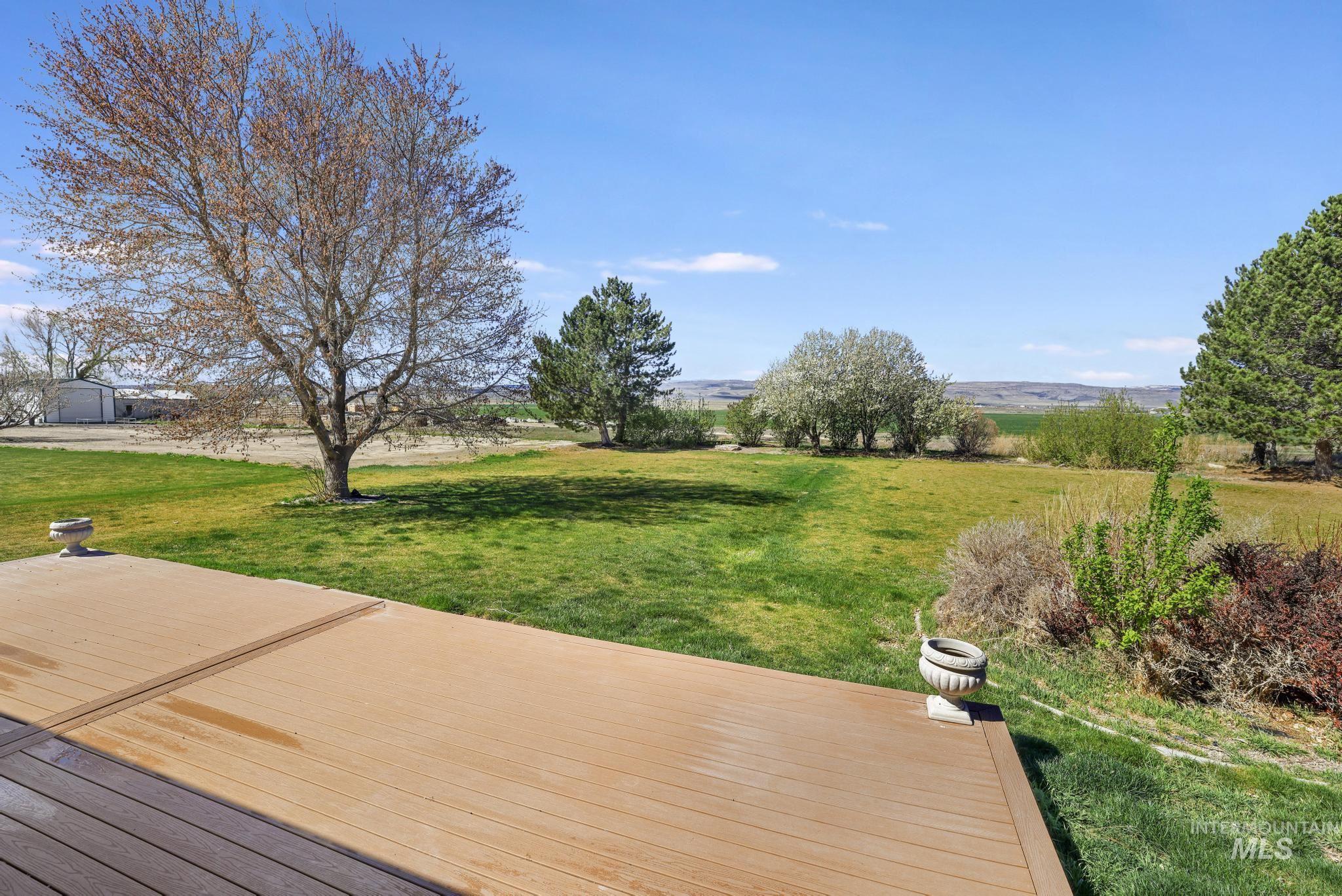 445 South College Street Oakley, ID 83346 - Photo 17 of 24 Wooden terrace featuring a yard and a rural view