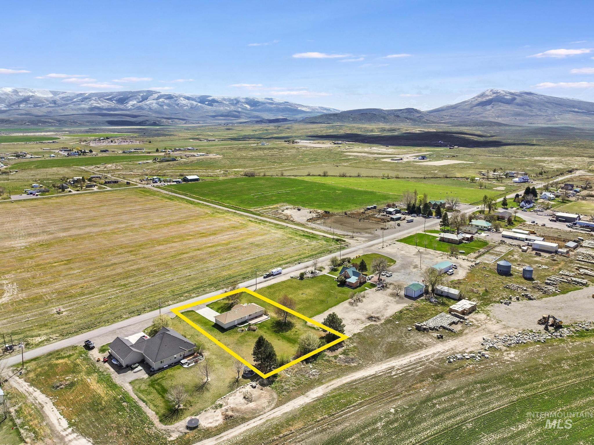 445 South College Street Oakley, ID 83346 - Photo 23 of 24 Aerial view of sparsely populated area featuring property parcel outlined and a mountain backdrop