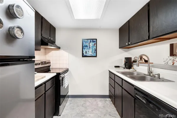 a kitchen with stainless steel appliances granite countertop a sink and cabinets