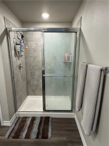 a bathroom with a glass door shower