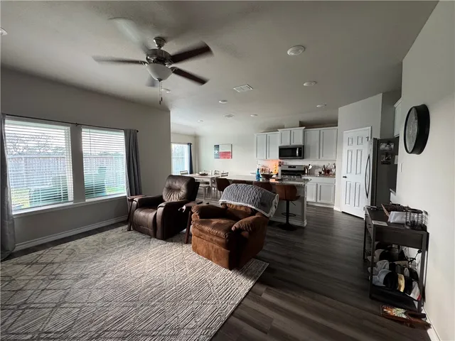 a living room with furniture and kitchen view