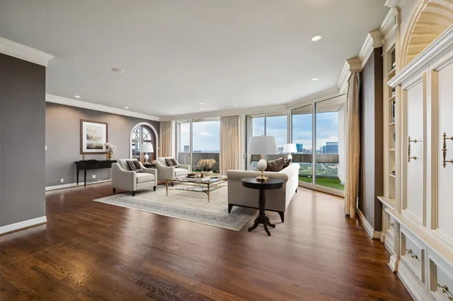 a living room with furniture a rug and a shelf