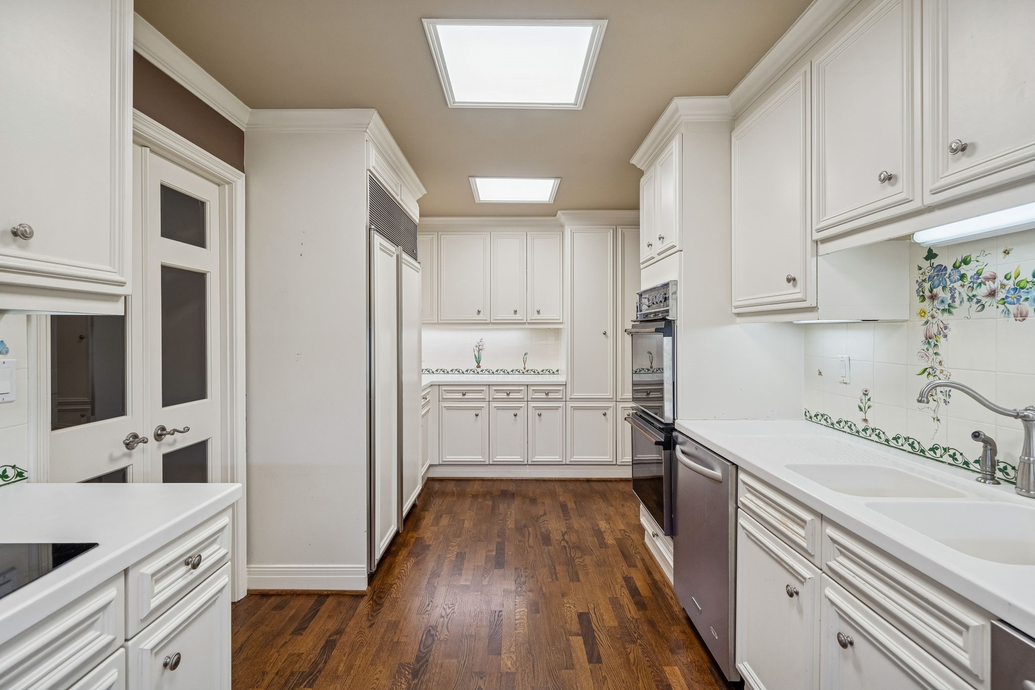1111 Hermann Drive, Unit 28D Houston, TX 77004 - Photo 15 of 49 a kitchen with a sink cabinets stainless steel appliances and a window