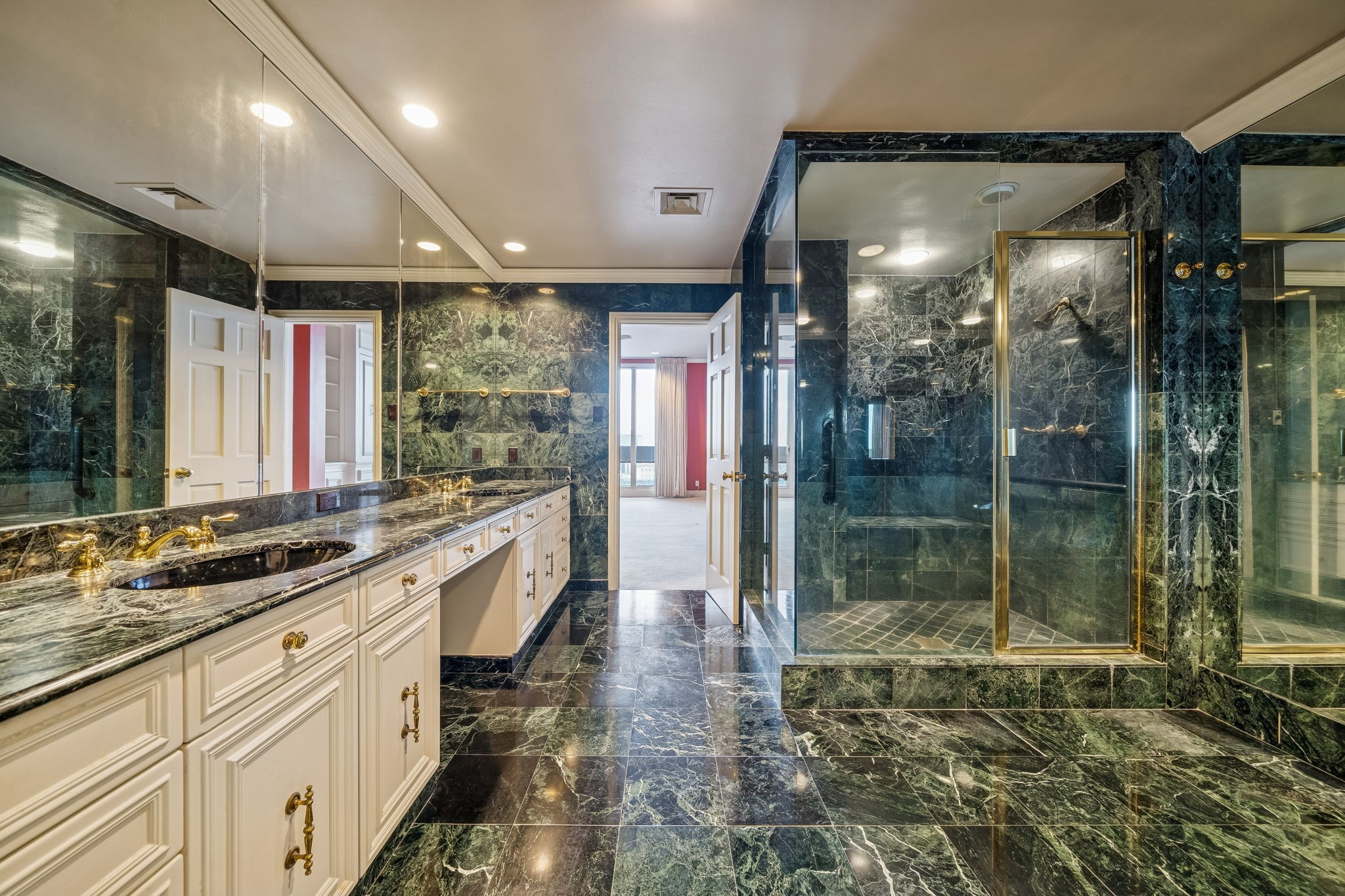 1111 Hermann Drive, Unit 28D Houston, TX 77004 - Photo 19 of 49 a large bathroom with a glass shower door and a sink