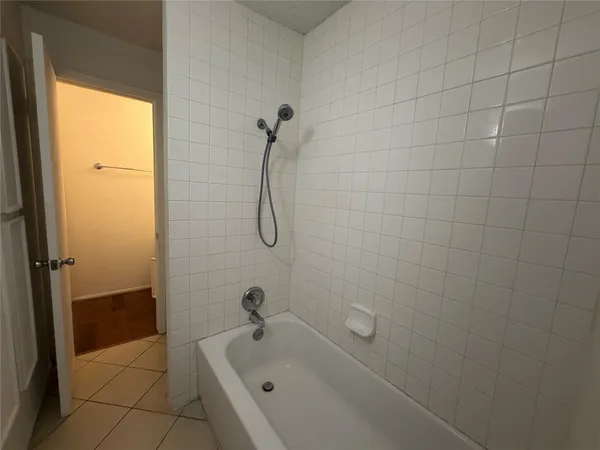 a bathroom with a tub and a shower