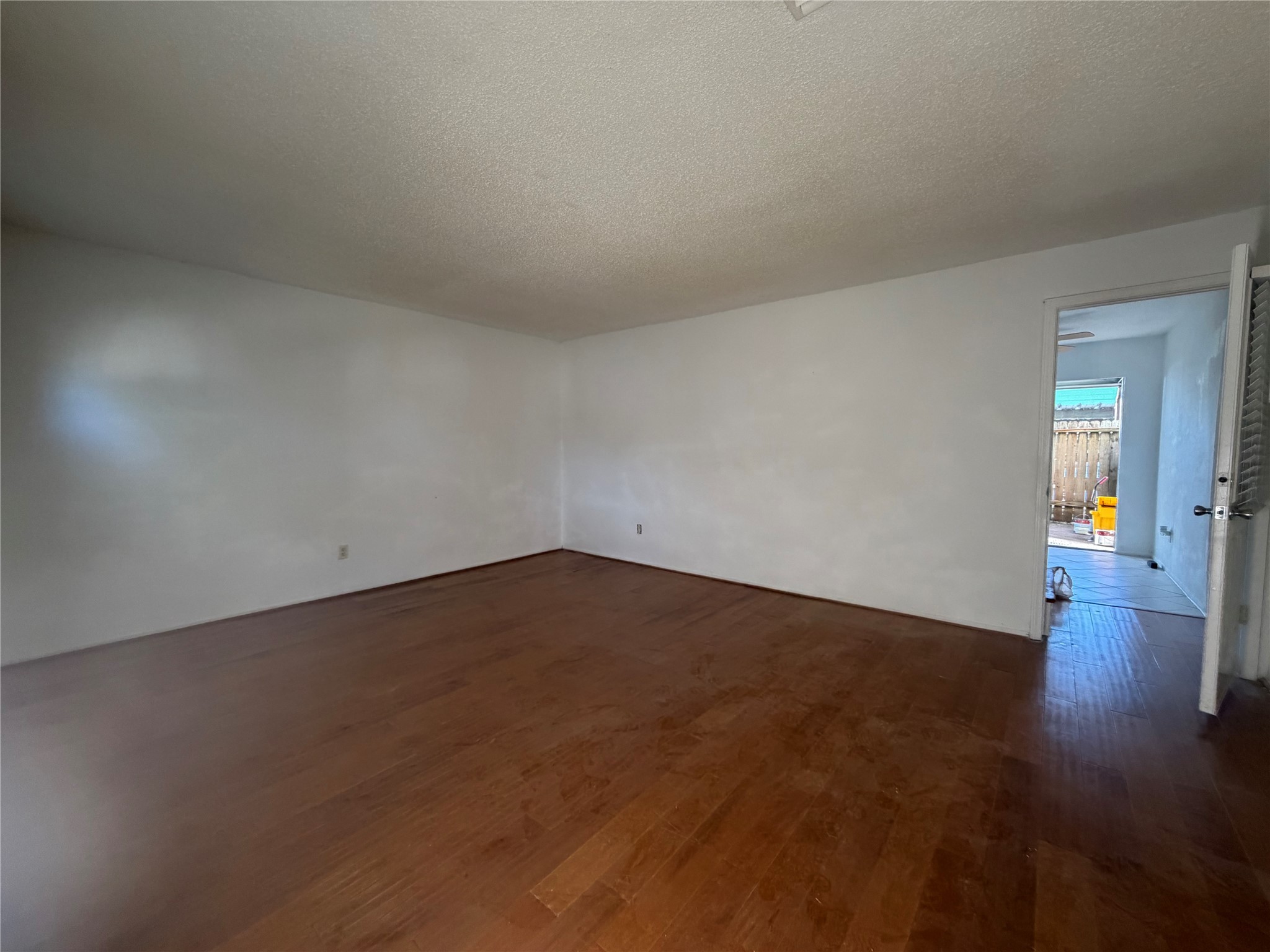 7821 Cook Road Houston, TX 77072 - Photo 2 of 15 an empty room with wooden floor and windows