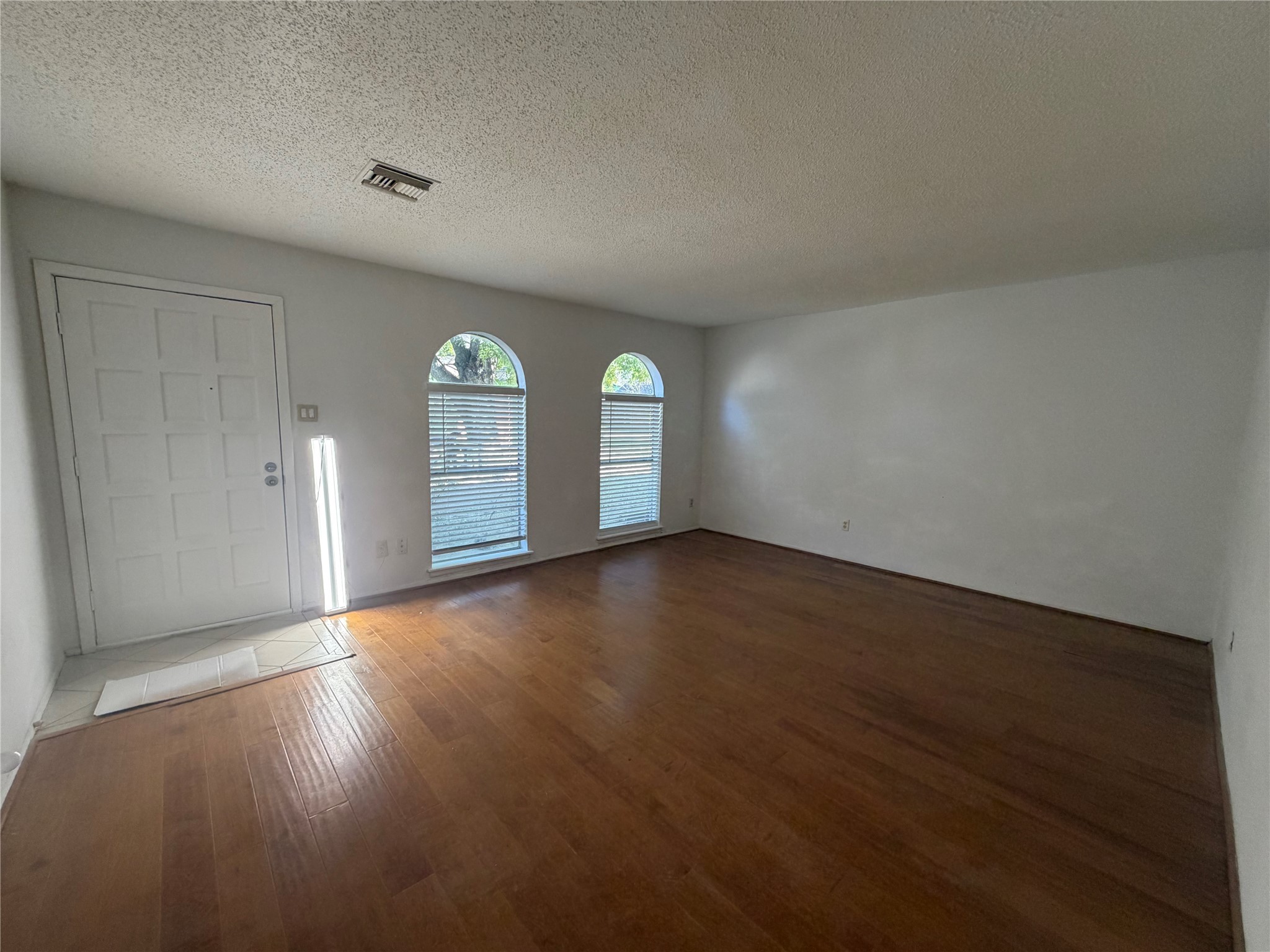 7821 Cook Road Houston, TX 77072 - Photo 3 of 15 a view of empty room with wooden floor