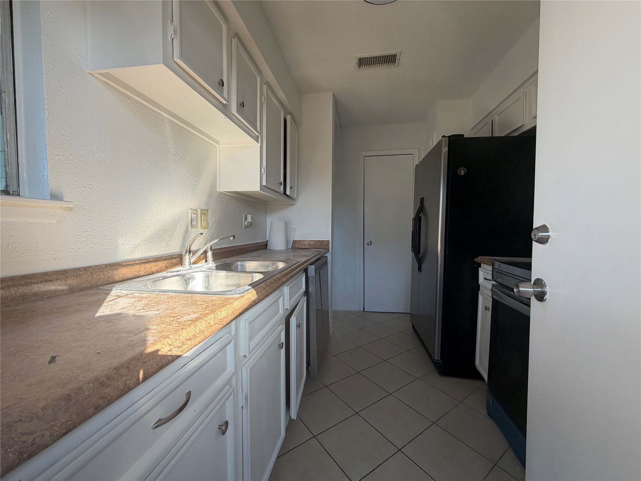 7821 Cook Road Houston, TX 77072 - Photo 6 of 15 a kitchen with stainless steel appliances granite countertop a refrigerator and a sink