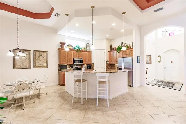 a kitchen with a sink and chairs