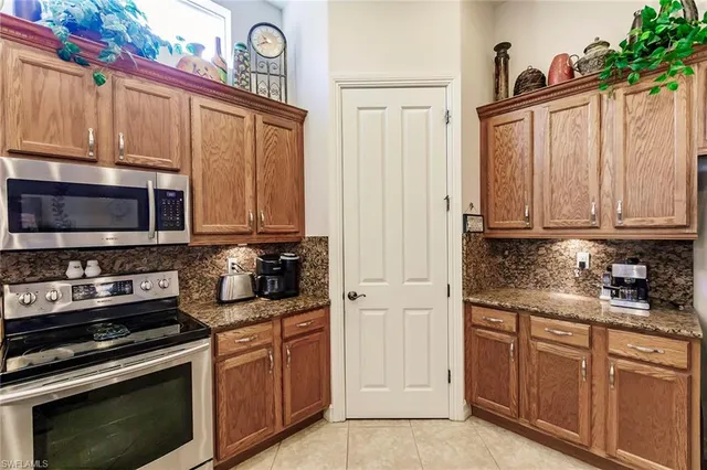 a kitchen with stainless steel appliances granite countertop a stove microwave and cabinets