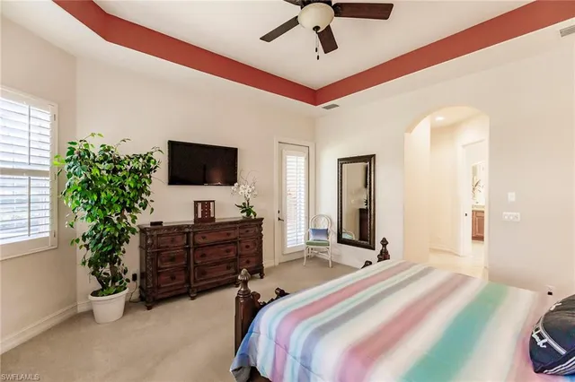 a bedroom with a bed and flat screen tv
