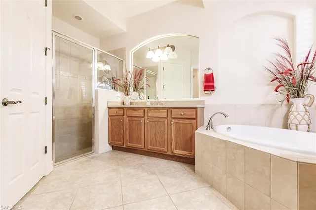 a spacious bathroom with a bathtub sink and mirror