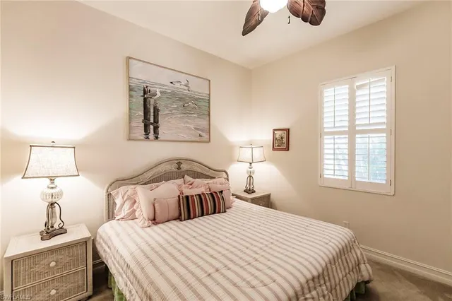 a bedroom with a bed and a lamp