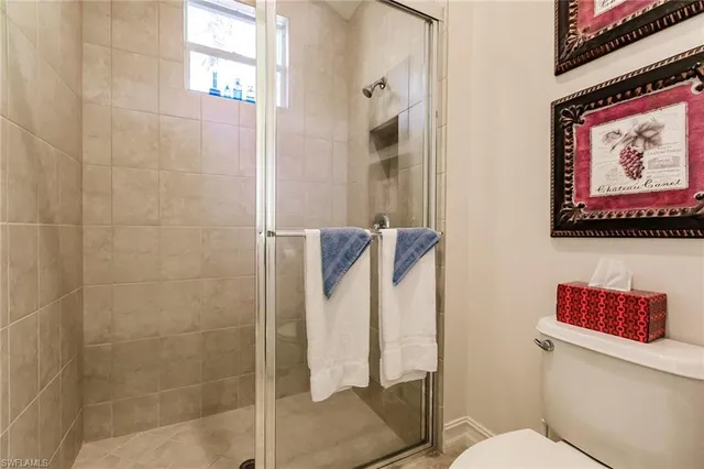 a bathroom with a toilet and a shower