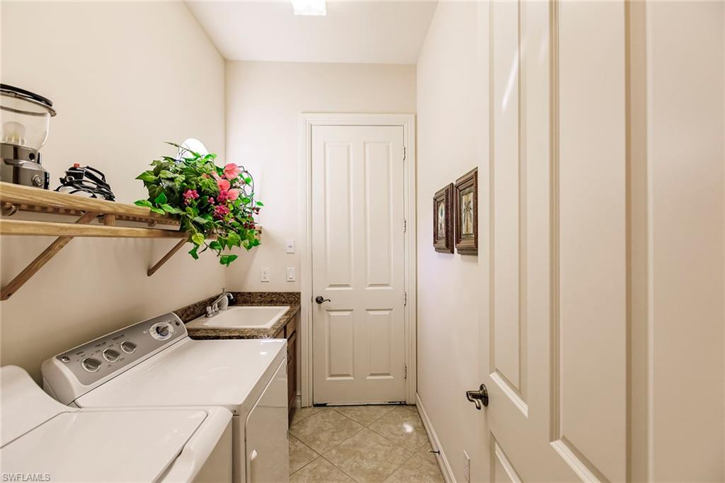 7684 Cottesmore Drive Naples, FL 34113 - Photo 42 of 46 a utility room with closet dryer and washer