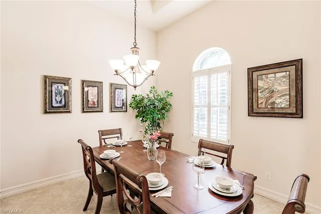 a view of a dining room with furniture a chandelier and wooden floor