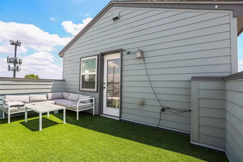 a view of a chairs and tables in the back yard of the house