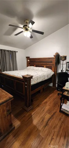 a bedroom with furniture and a wooden floor