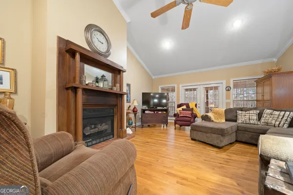a living room with furniture a fireplace and a flat screen tv