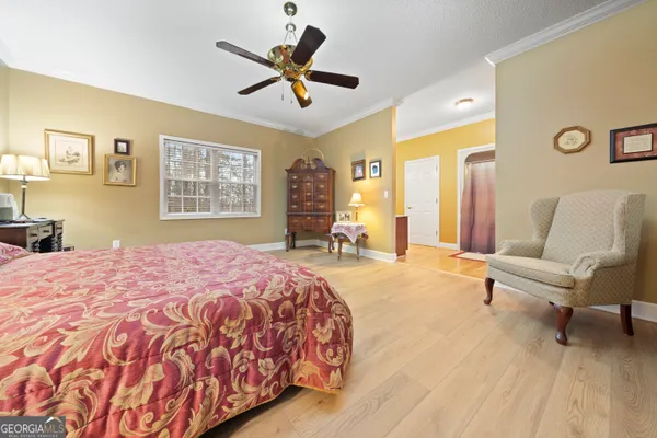 a spacious bedroom with a bed a couch and a window