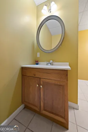 a bathroom with a sink mirror vanity and a mirror