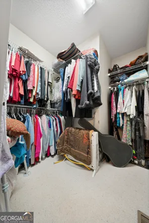a view of walk in closet with clothes