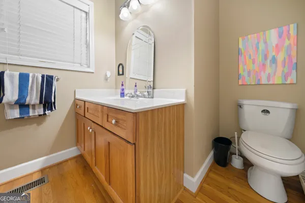 a bathroom with a sink a toilet and a mirror
