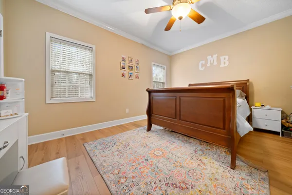 a living room with a bed furniture and a window