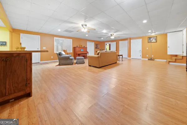 a room with lots of furniture and a large window