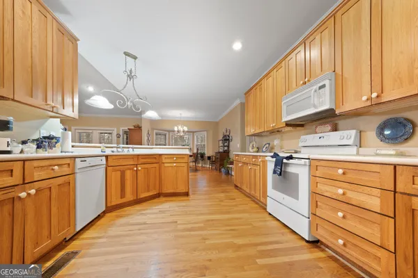 a kitchen with stainless steel appliances kitchen island granite countertop a sink a stove and cabinets