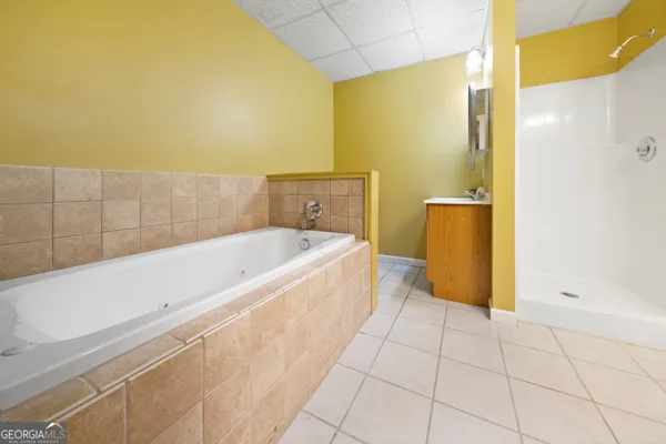 a bathroom with a bathtub and shower